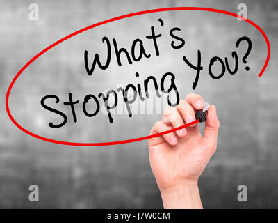 Man Hand writing What's Stopping You?  with black marker on visual screen. Isolated on grey. Business, technology, internet concept. Stock Photo Stock Photo