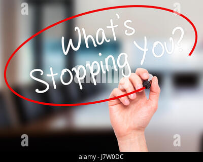 Man Hand writing What's Stopping You?  with black marker on visual screen. Isolated on office. Business, technology, internet concept. Stock Photo Stock Photo