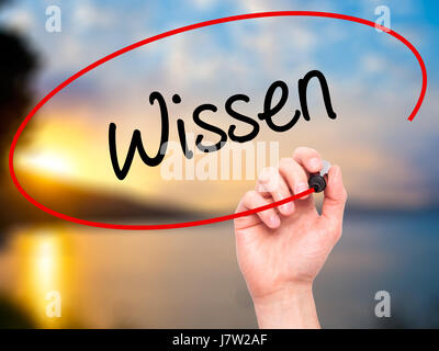 Man Hand writing Wissen (Know in German)  with black marker on visual screen. Isolated on background. Business, technology, internet concept. Stock Ph Stock Photo