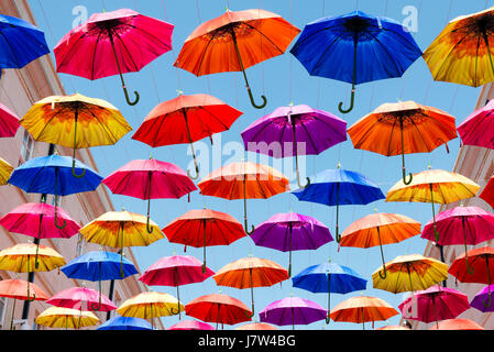 Bath, Somerset, UK. Colourful umbrellas suspended above the street as part of an art festival. Stock Photo