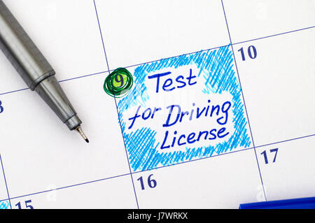 Reminder Test for Driving License in calendar with blue pen. Stock Photo
