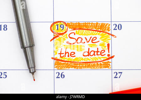Reminder Save the Date in calendar with red pen. Stock Photo