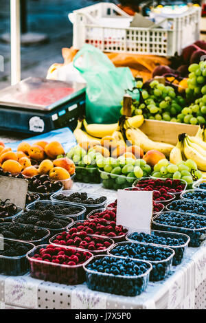 Berries in boxes on the market. Market Showcase with berries. The market in the old town of Dubrovnik, Croatia. Stock Photo