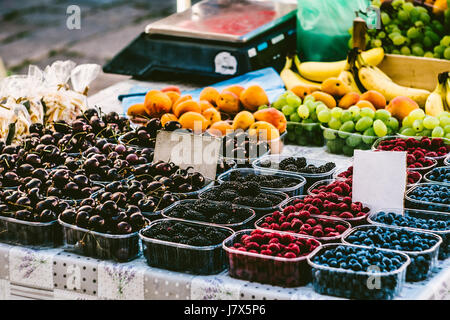 Berries in boxes on the market. Market Showcase with berries. The market in the old town of Dubrovnik, Croatia. Stock Photo