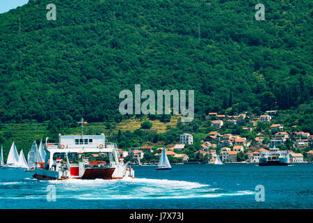 A ferry in the Boka Bay of Kotor in Montenegro, from Lepetane to Kamenari. Car ferry across the bay. Stock Photo