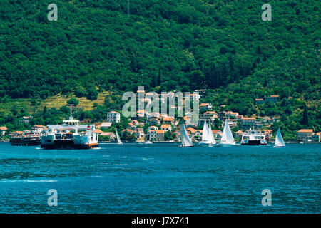 A ferry in the Boka Bay of Kotor in Montenegro, from Lepetane to Kamenari. Car ferry across the bay. Stock Photo