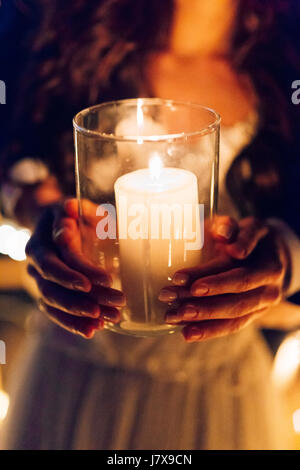 A candle in the hands of a newlywed couple. Wedding in Montenegr Stock Photo