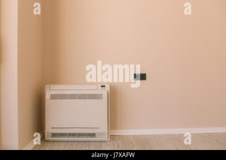 Square air conditioner in the apartment. On the floor, split sys Stock Photo