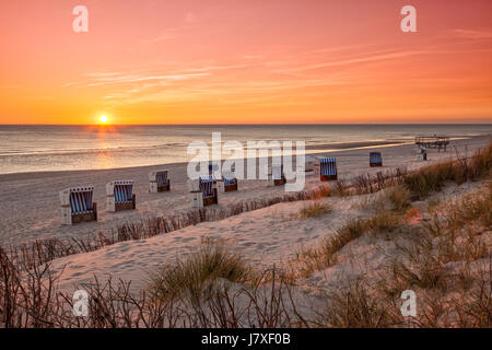 Beach chairs at North Sea beach of Hörnum, Sylt, in sunset Stock Photo