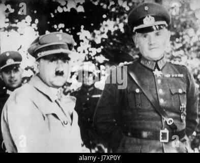 Chancellor Adolf Hitler stands with General Werner von Bromberg, the Minister of Defense, August 3, 1934.  Only the day before, Germany's President, Paul von Hindenburg had died. On August 3, with the support of the army, Hitler became President. At this photographed ceremony, Gen. von Bromberg pledged the Army to Hitler, and von Bomberg [according to this photo's caption], 'Ordered each soldier to pledge his loyalty and life to' Hitler.   To see my other vintage WW II images, Search:  Prestor  vintage   WW II Stock Photo