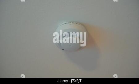 the smoke detector alarm on belom the ceiling in the apartment Stock Photo
