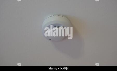 the smoke detector alarm on belom the ceiling in the apartment Stock Photo