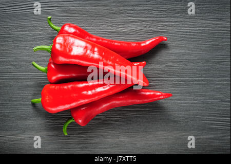 Sweet red Kapia peppers on a dark shale stone background Stock Photo