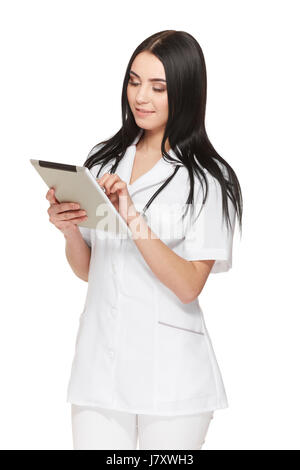 Doctor in uniform using tablet and reading information about patient. Stock Photo