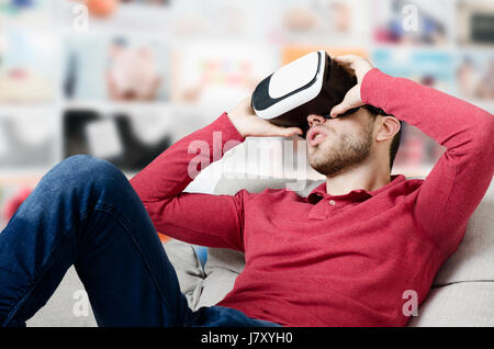 The man is excited about the virtual reality in 3D glasses. Multimedia stream in background Stock Photo
