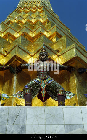Buddhist demon caryatid on the base of one of the two Golden Phra Chedis, Emerald Buddha Temple (Wat Phra Keo), Bangkok, Thailand Stock Photo