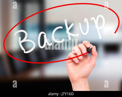Man Hand writing Backup with marker on transparent wipe board. Isolated on office. Business, internet, technology concept.  Stock Photo Stock Photo