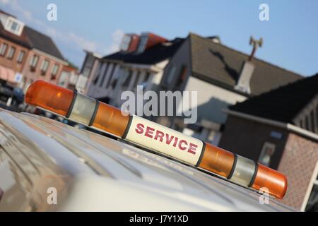 service vehicle with yellow beacon lights in urban area Stock Photo