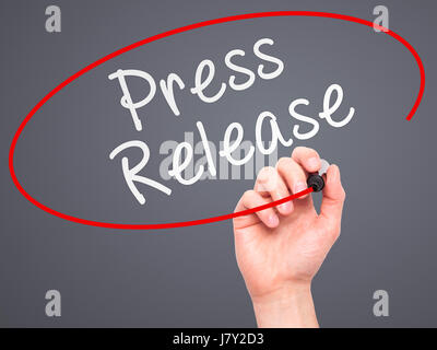 Man Hand writing Press Release with marker on transparent wipe board. Isolated on grey. Business, internet, technology concept. Stock Photo Stock Photo
