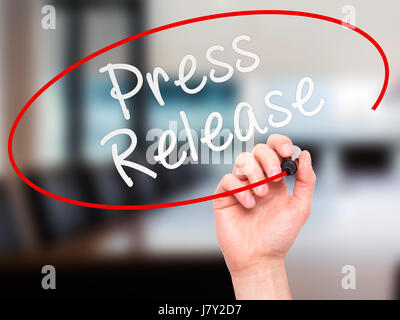 Man Hand writing Press Release with marker on transparent wipe board. Isolated on office. Business, internet, technology concept. Stock Photo Stock Photo