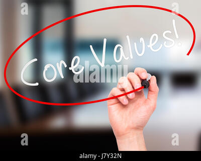 Man Hand writing Core Values with marker on transparent wipe board. Isolated on office. Business, internet, technology concept. Stock Photo Stock Photo
