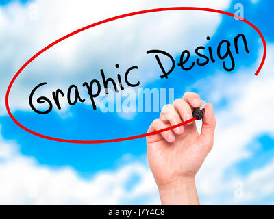 Man Hand writing Graphic Design with marker on transparent wipe board. Isolated on sky. Business, internet, technology concept. Stock Photo Stock Photo