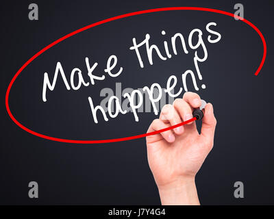 Man Hand writing Make Things Happen with marker on transparent wipe board. Isolated on black. Business, internet, technology concept. Stock Photo Stock Photo