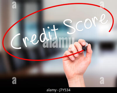 Man Hand writing Credit Score black marker on visual screen. Isolated on office. Business, technology, internet concept. Stock Image Stock Photo