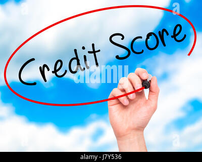 Man Hand writing Credit Score black marker on visual screen. Isolated on sky. Business, technology, internet concept. Stock Image Stock Photo