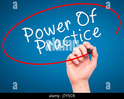 Man Hand writing Power Of Practice with black marker on visual screen. Isolated on blue. Business, technology, internet concept. Stock Image Stock Photo