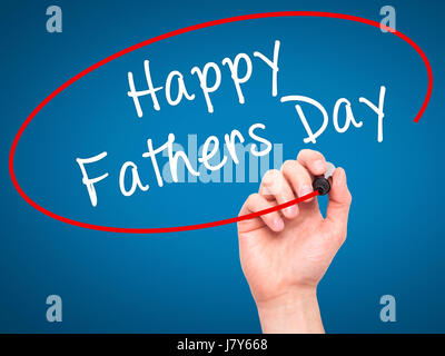 Man Hand writing Happy Fathers Day with black marker on visual screen. Isolated on blue. Business, technology, internet concept. Stock Image Stock Photo