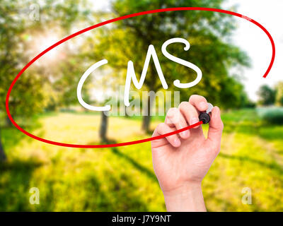 Man Hand writing CMS (Custom Management System) with black marker on visual screen. Isolated on background. Business, technology, internet concept. St Stock Photo
