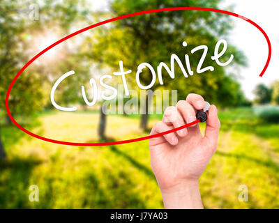 Man Hand writing  Customize with black marker on visual screen. Isolated on nature. Business, technology, internet concept. Stock Photo Stock Photo