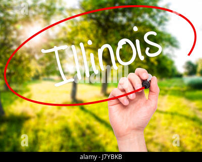 Man Hand writing Illinois with black marker on visual screen. Isolated on background. Business, technology, internet concept. Stock Photo Stock Photo