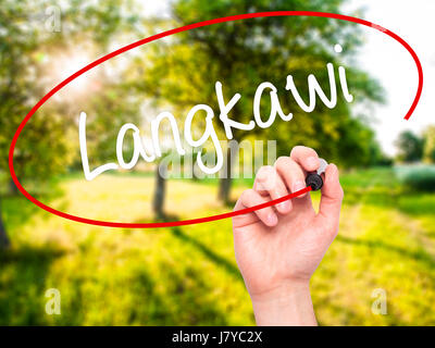 Man Hand writing Langkawi  with black marker on visual screen. Isolated on background. Business, technology, internet concept. Stock Photo Stock Photo