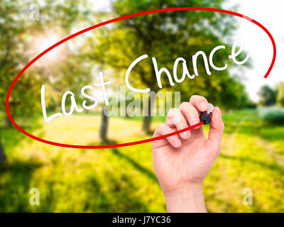 Man Hand writing Last Chance with black marker on visual screen. Isolated on background. Business, technology, internet concept. Stock Photo Stock Photo