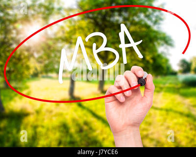 Man Hand writing MBA with black marker on visual screen. Isolated on ...