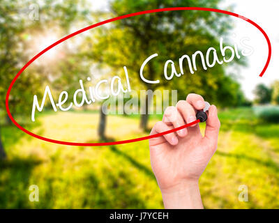Man Hand writing Medical Cannabis with black marker on visual screen. Isolated on background. Business, technology, internet concept. Stock Photo Stock Photo