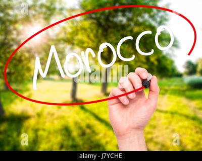 Man Hand writing Morocco  with black marker on visual screen. Isolated on background. Business, technology, internet concept. Stock Photo Stock Photo