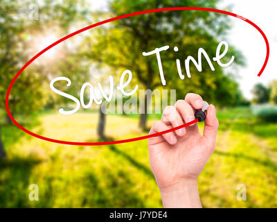 Man Hand writing Save Time with black marker on visual screen. Isolated on nature. Business, technology, internet concept. Stock Photo Stock Photo