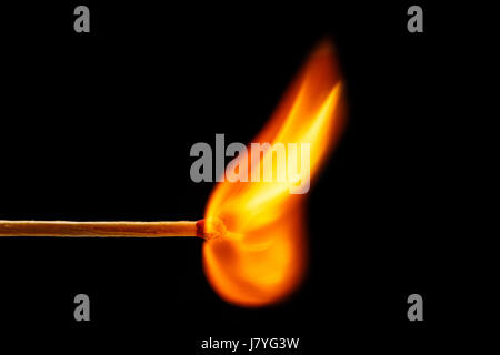 Macro fire burning on matchstick. Studio shot isolated on black background Stock Photo