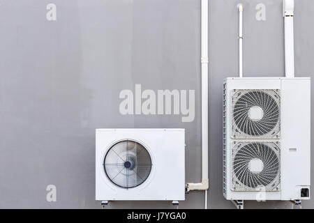 Outdoor air conditioning compressor installed the wall Stock Photo