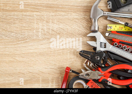 Close up new of assorted work tools on wood with copy space for text Stock Photo