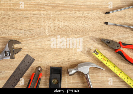 Close up new of assorted work tools on wood with copy space for text Stock Photo