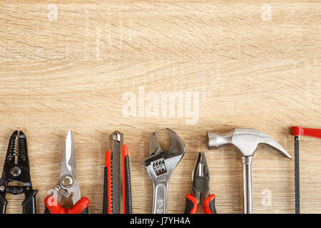 Close up new of assorted work tools on wood with copy space for text Stock Photo