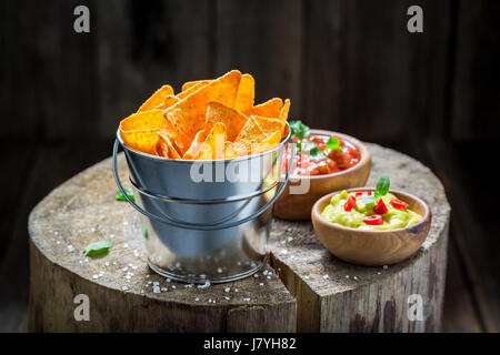 Mexican nachos with tomato dip and coriander Stock Photo