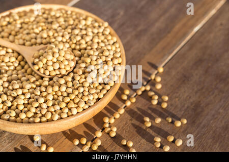 Close up soybean in bowl on wooden table background Stock Photo