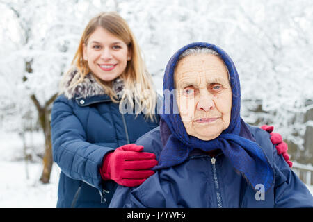 Picture of a caring young woman helping her old grandmother Stock Photo