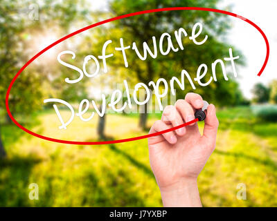 Man Hand writing Software Development with black marker on visual screen. Isolated on background. Business, technology, internet concept. Stock Photo Stock Photo