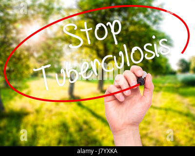Man Hand writing Stop Tuberculosis with black marker on visual screen. Isolated on background. Business, technology, internet concept. Stock Photo Stock Photo